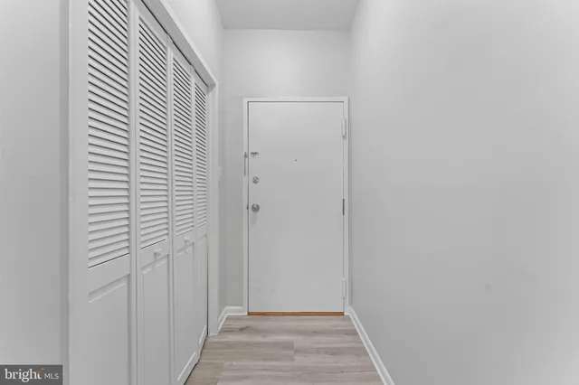 a view of an empty room and wooden floor