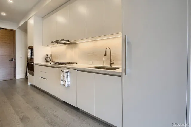 a kitchen with stainless steel appliances granite countertop a sink and a stove