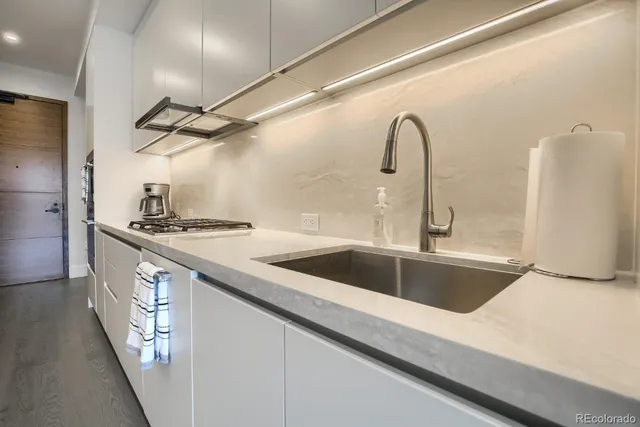 a kitchen with a sink and a refrigerator