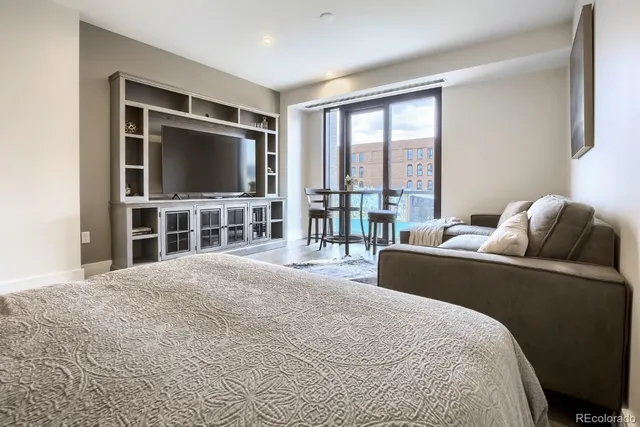 a bedroom with a bed and a flat screen tv