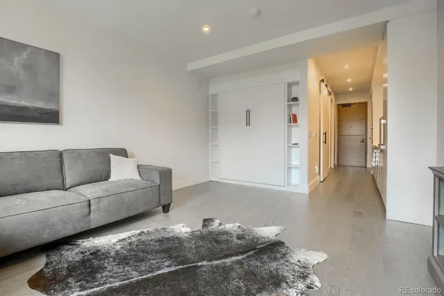 a living room with furniture and a rug
