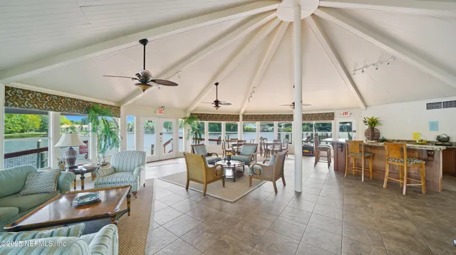 a room with lots of furniture and white walls