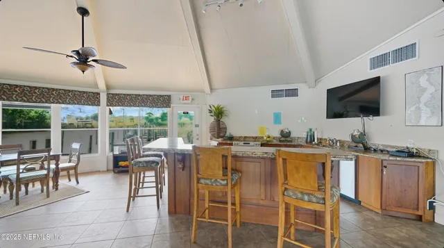 a room with pool table and windows