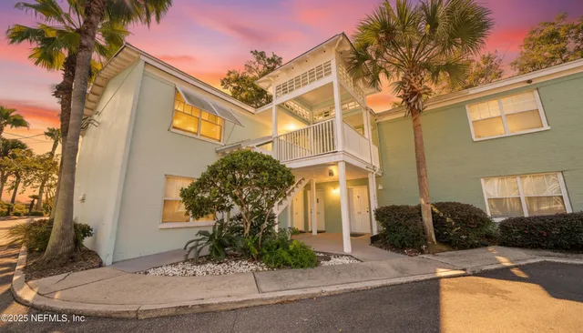 a front view of a house with a yard and a garage