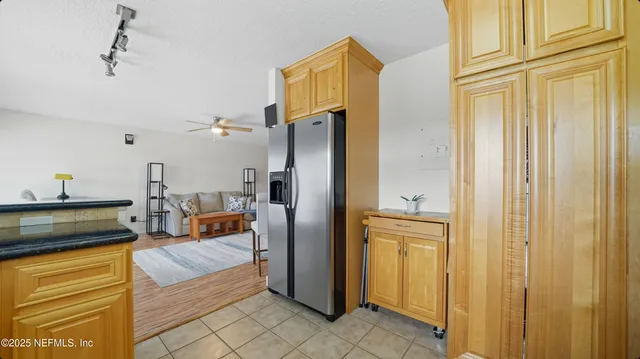 a kitchen with stainless steel appliances granite countertop a refrigerator and a stove top oven