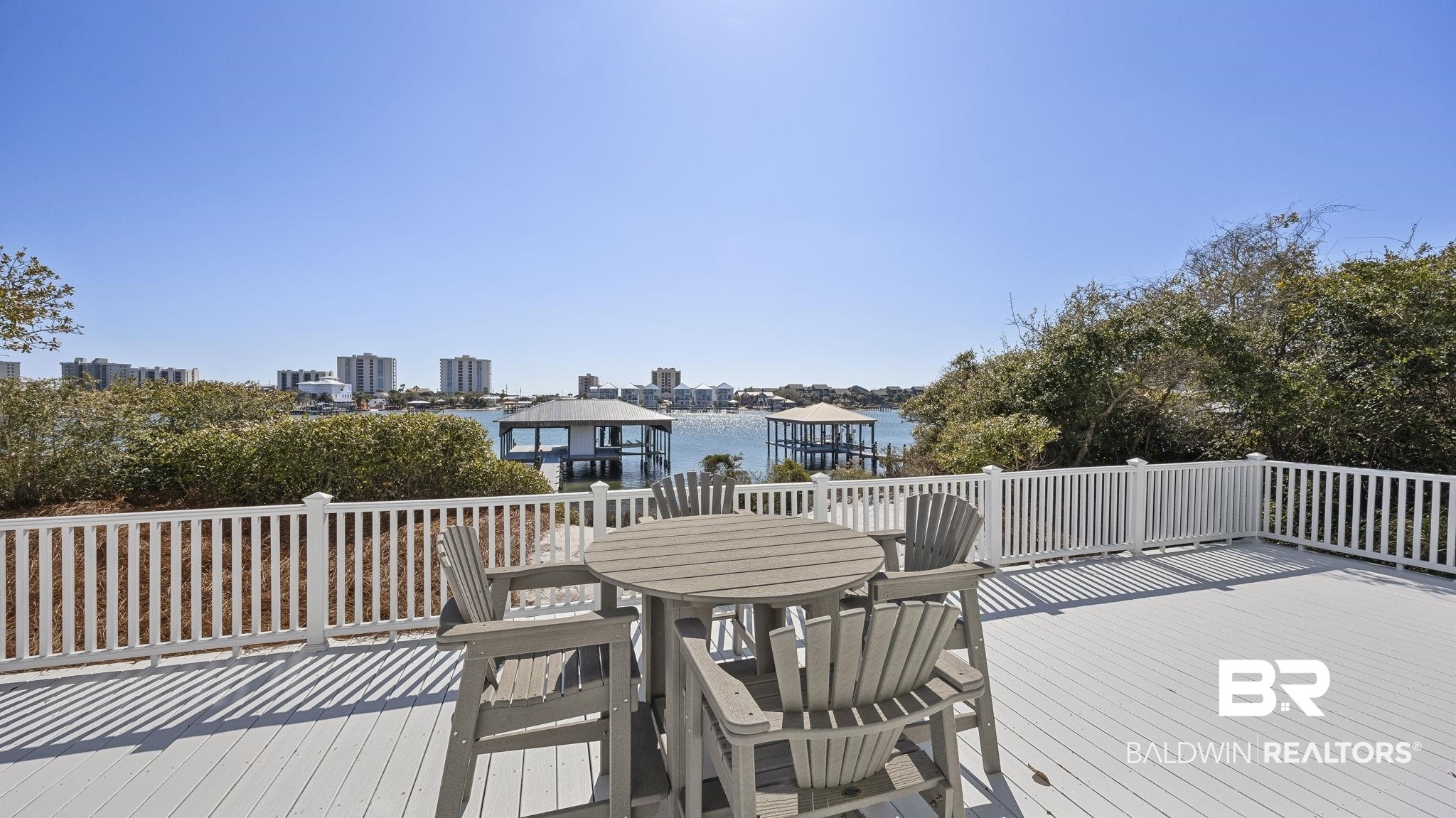 30194 River Road Orange Beach, AL 36561 - Photo 32 of 45 Deck with outdoor dining space and a water view