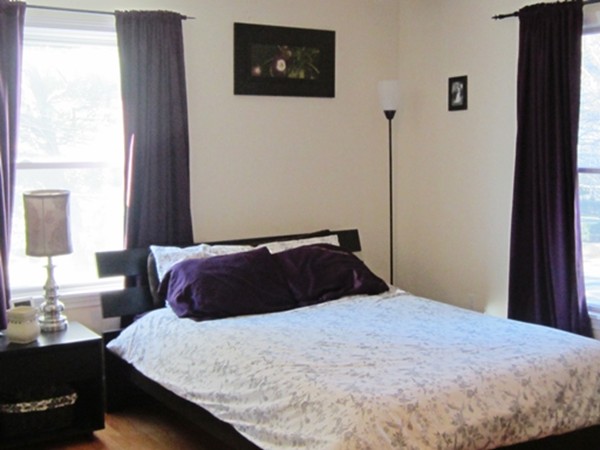 139 Linden Street, Unit 2 Wellesley, MA 02482 - Photo 5 of 9 a bedroom with a large bed and a chandelier