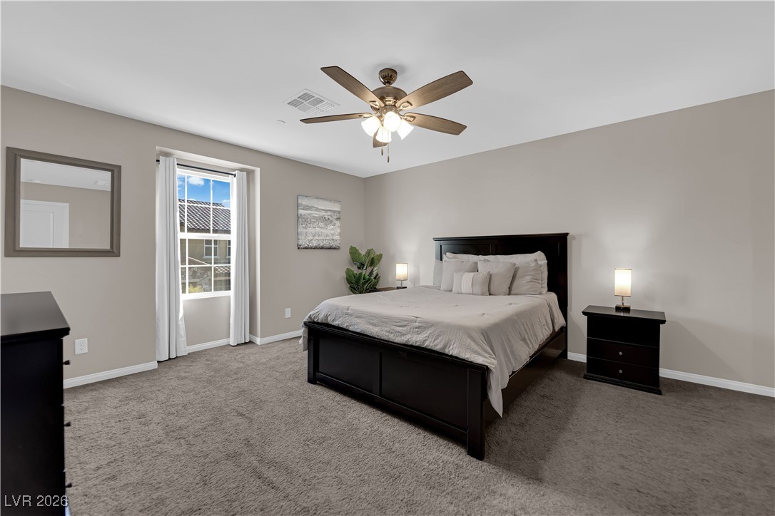 2606 Ercolano Street Henderson, NV 89044 - Photo 21 of 46 Expansive primary suite includes a ceiling fan & light, two tone paint, curtains & walk-in closet.