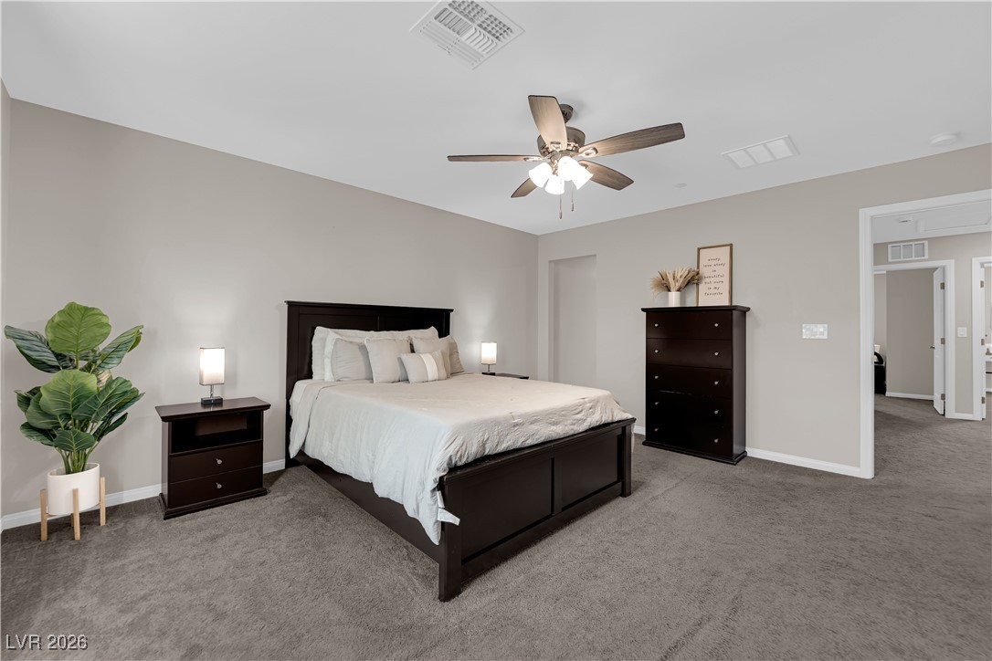 2606 Ercolano Street Henderson, NV 89044 - Photo 22 of 46 Expansive primary suite includes a ceiling fan & light, two tone paint, curtains & walk-in closet.