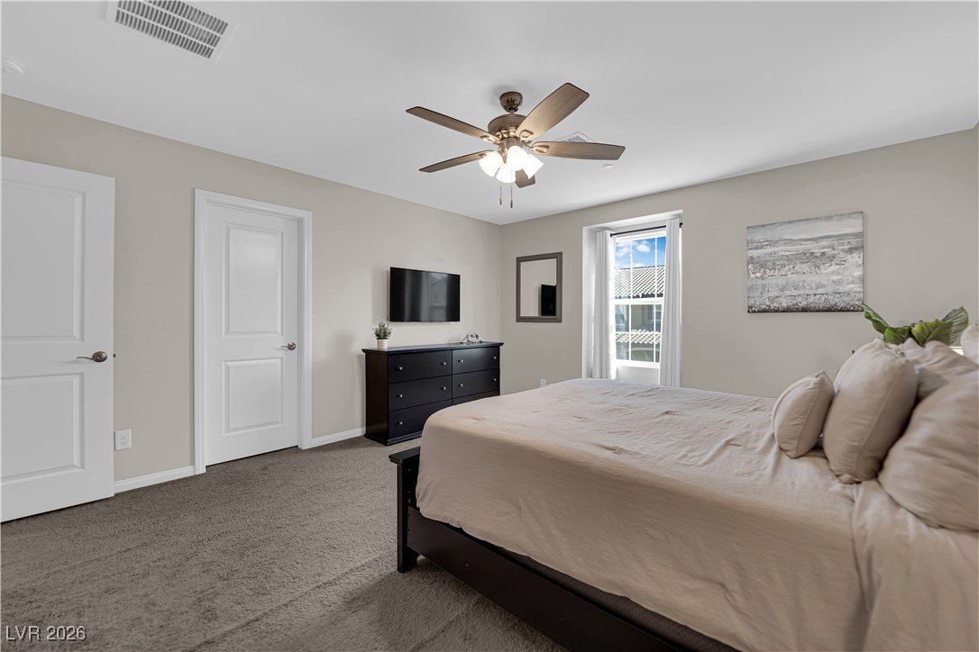 2606 Ercolano Street Henderson, NV 89044 - Photo 23 of 46 Expansive primary suite includes a ceiling fan & light, two tone paint, curtains & walk-in closet.