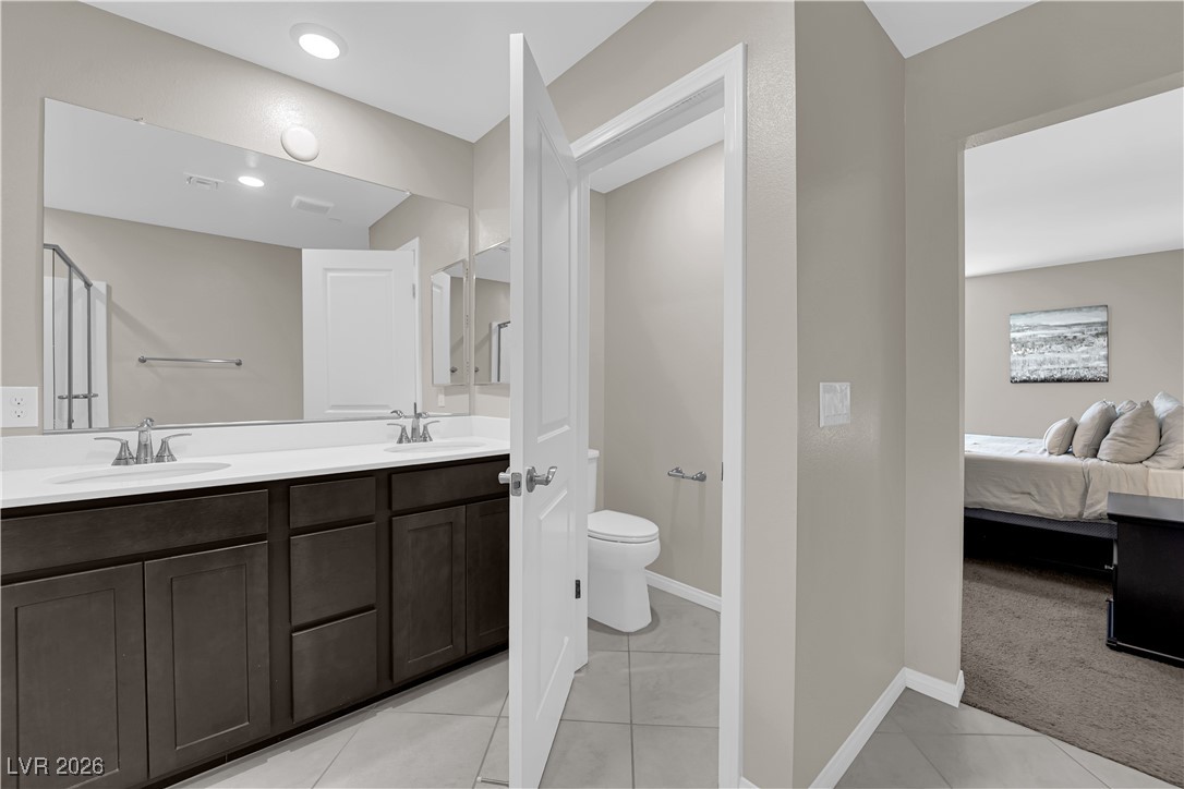 2606 Ercolano Street Henderson, NV 89044 - Photo 26 of 46 Primary bath w/espresso cabinets, quartz counters, dual sinks and sep tub & shower.