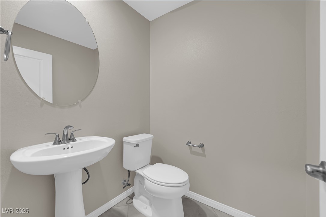 2606 Ercolano Street Henderson, NV 89044 - Photo 33 of 46 Guest 1/2 bathroom w/tile floors & two tone paint