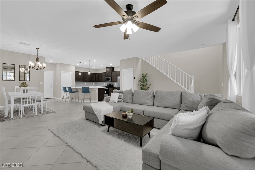 2606 Ercolano Street Henderson, NV 89044 - Photo 7 of 46 Great room w/ceiling fan & light, tile floors & two tone paint.