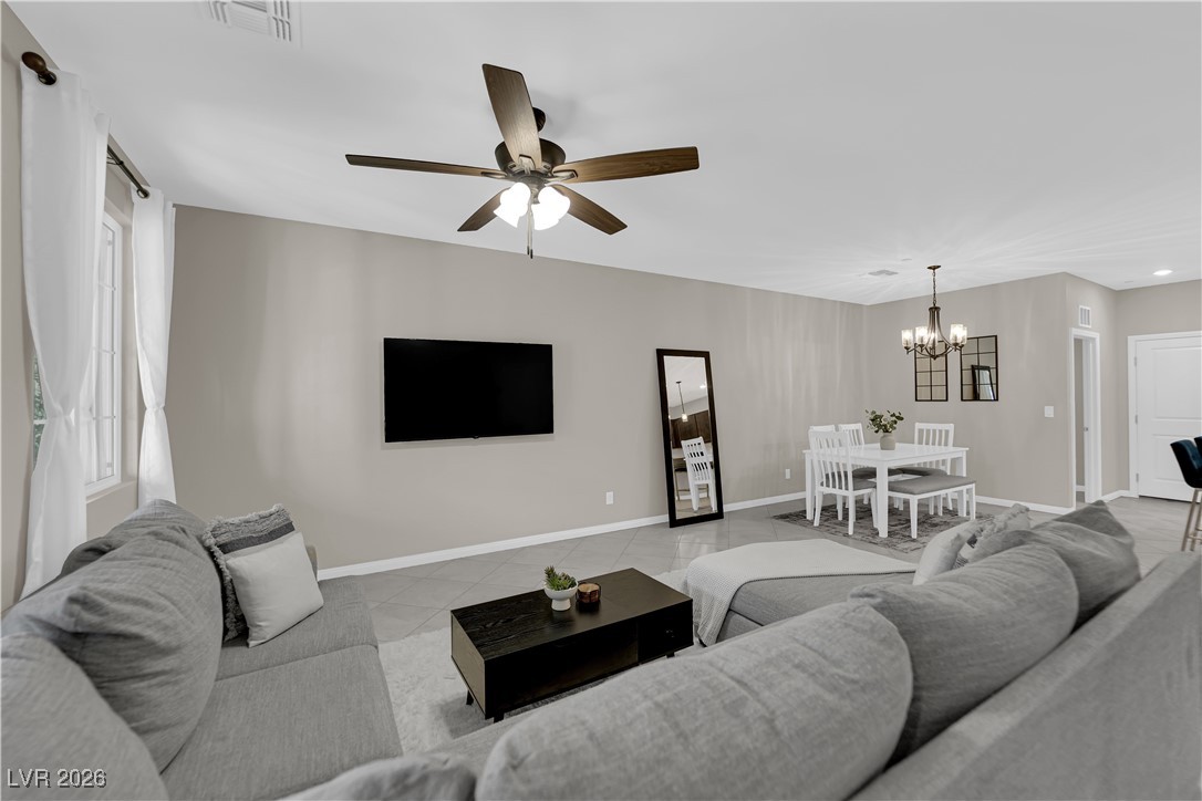 2606 Ercolano Street Henderson, NV 89044 - Photo 10 of 46 Great room w/ceiling fan & light, tile floors & two tone paint.