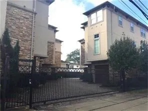a front view of a house with plants