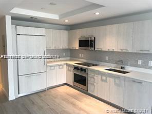 55 Southwest 9th Street, Unit 2504 Miami, FL 33130 - Photo 1 of 29 a kitchen with granite countertop a sink stove and refrigerator