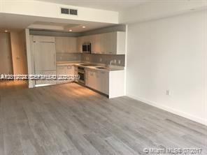 55 Southwest 9th Street, Unit 2504 Miami, FL 33130 - Photo 2 of 29 a view of kitchen with granite countertop cabinets and a sink