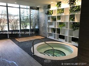 55 Southwest 9th Street, Unit 2504 Miami, FL 33130 - Photo 23 of 29 a view of swimming pool with a couch and floor to ceiling window