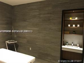 55 Southwest 9th Street, Unit 2504 Miami, FL 33130 - Photo 26 of 29 a bathroom with a sink and a mirror