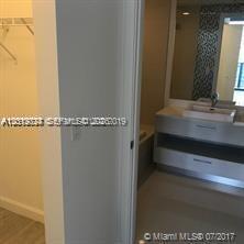 55 Southwest 9th Street, Unit 2504 Miami, FL 33130 - Photo 7 of 29 a bathroom with a sink and a mirror