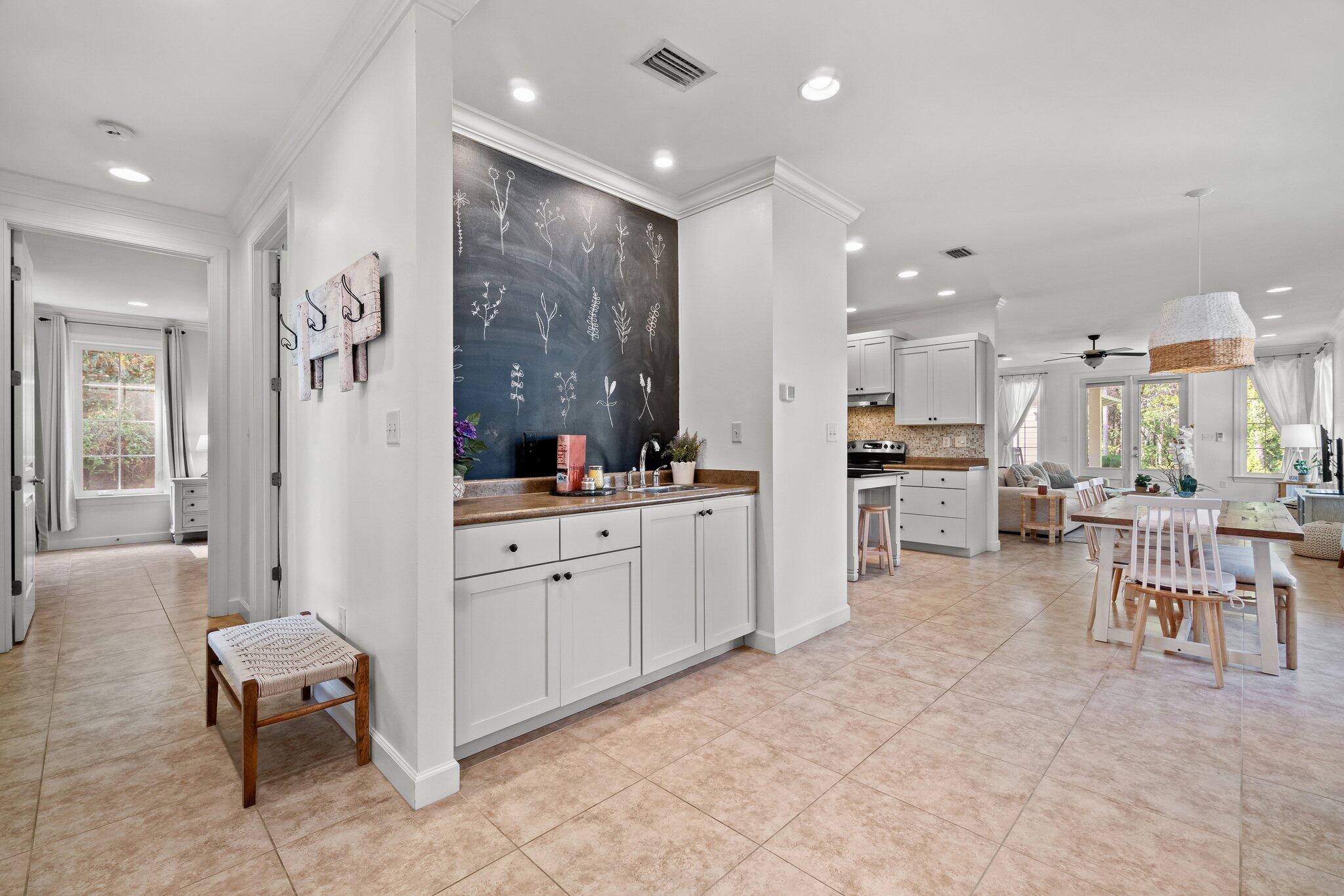 124 East Wild Blueberry Way Santa Rosa Beach, FL 32459 - Photo 11 of 38 a large white kitchen with lots of counter space and furniture