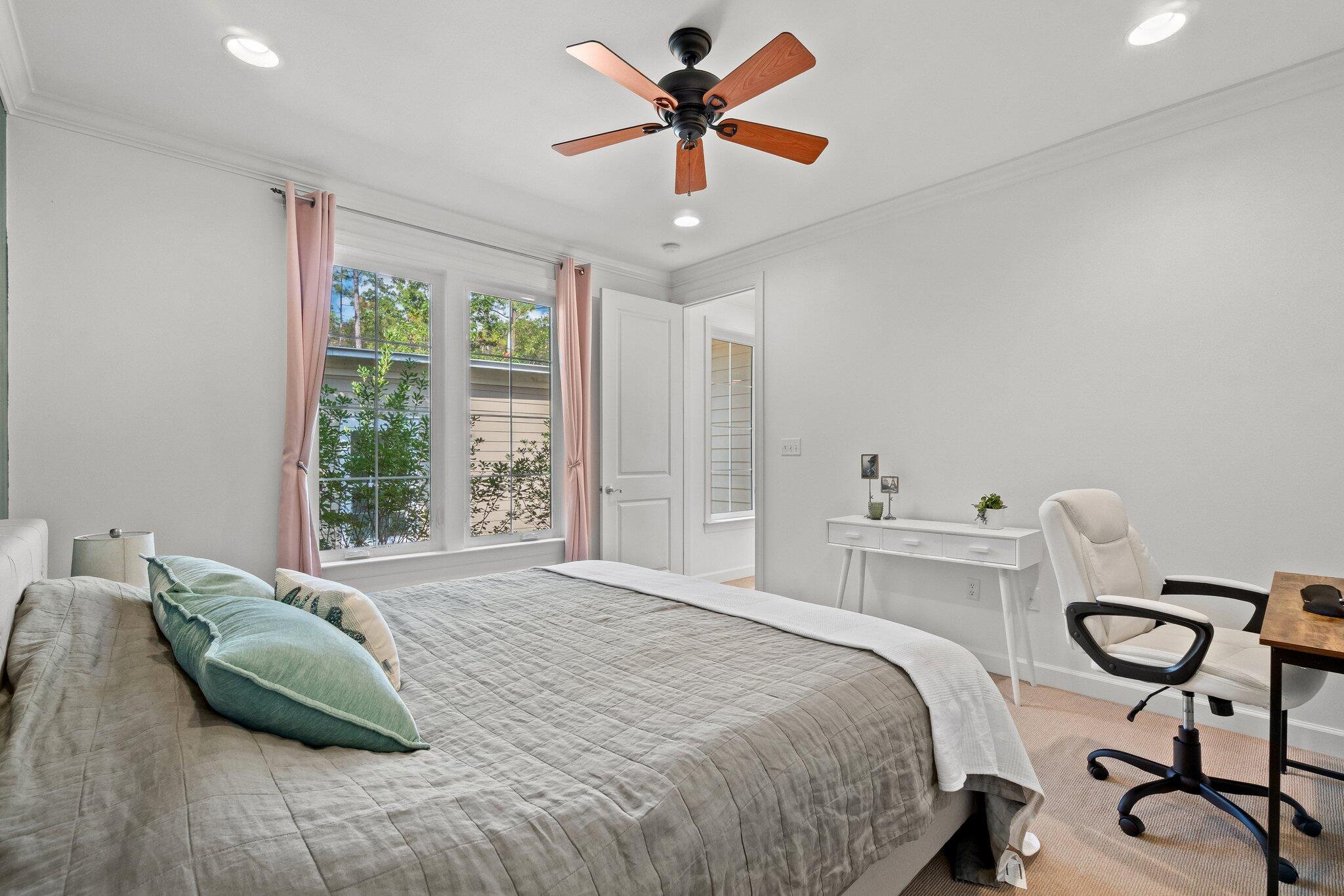 124 East Wild Blueberry Way Santa Rosa Beach, FL 32459 - Photo 15 of 38 a bedroom with a bed and a chandelier