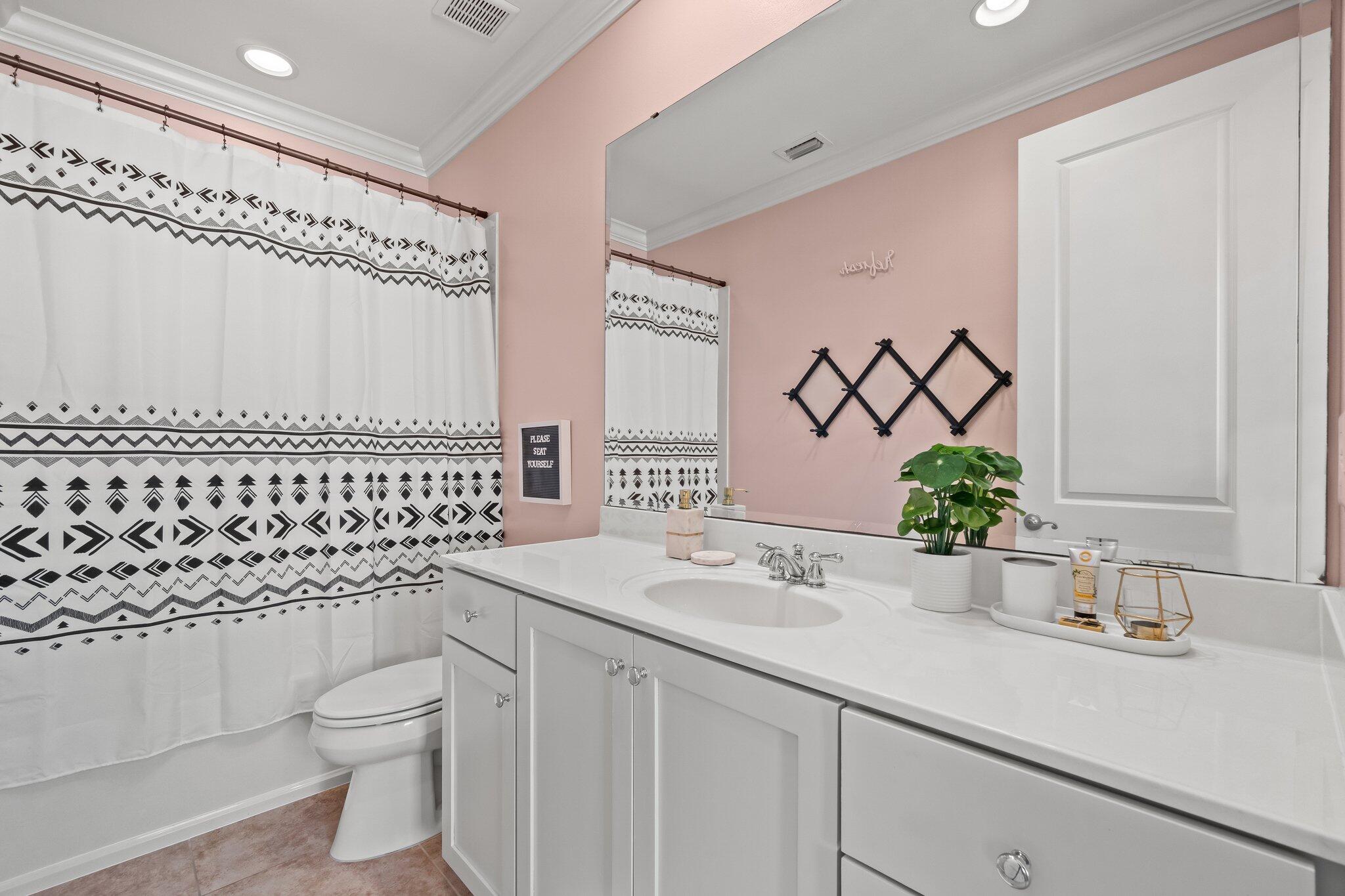 124 East Wild Blueberry Way Santa Rosa Beach, FL 32459 - Photo 16 of 38 a bathroom with a granite countertop sink a toilet and a mirror