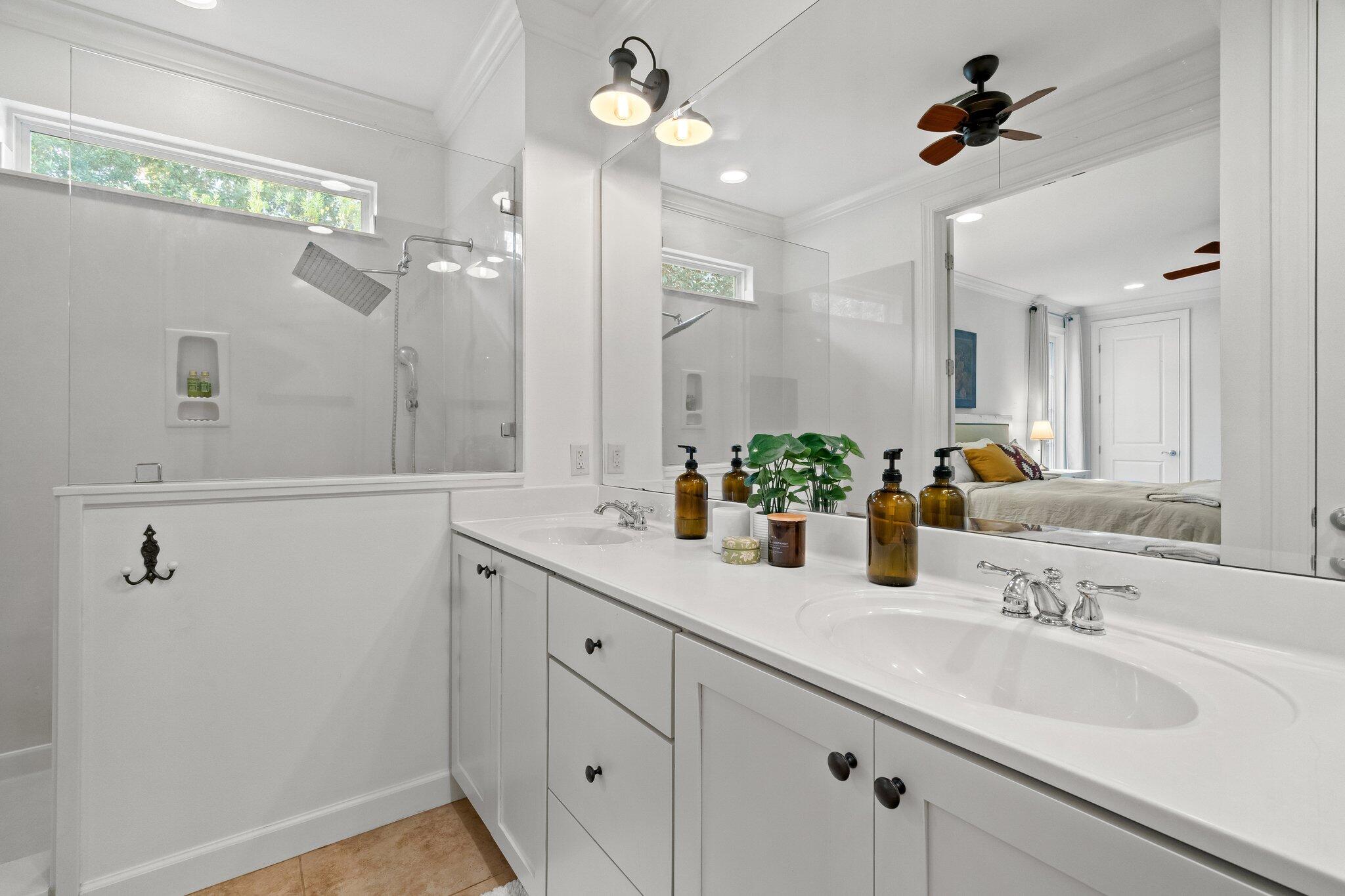 124 East Wild Blueberry Way Santa Rosa Beach, FL 32459 - Photo 21 of 38 a bathroom with a sink a faucet a potted plant and a shower