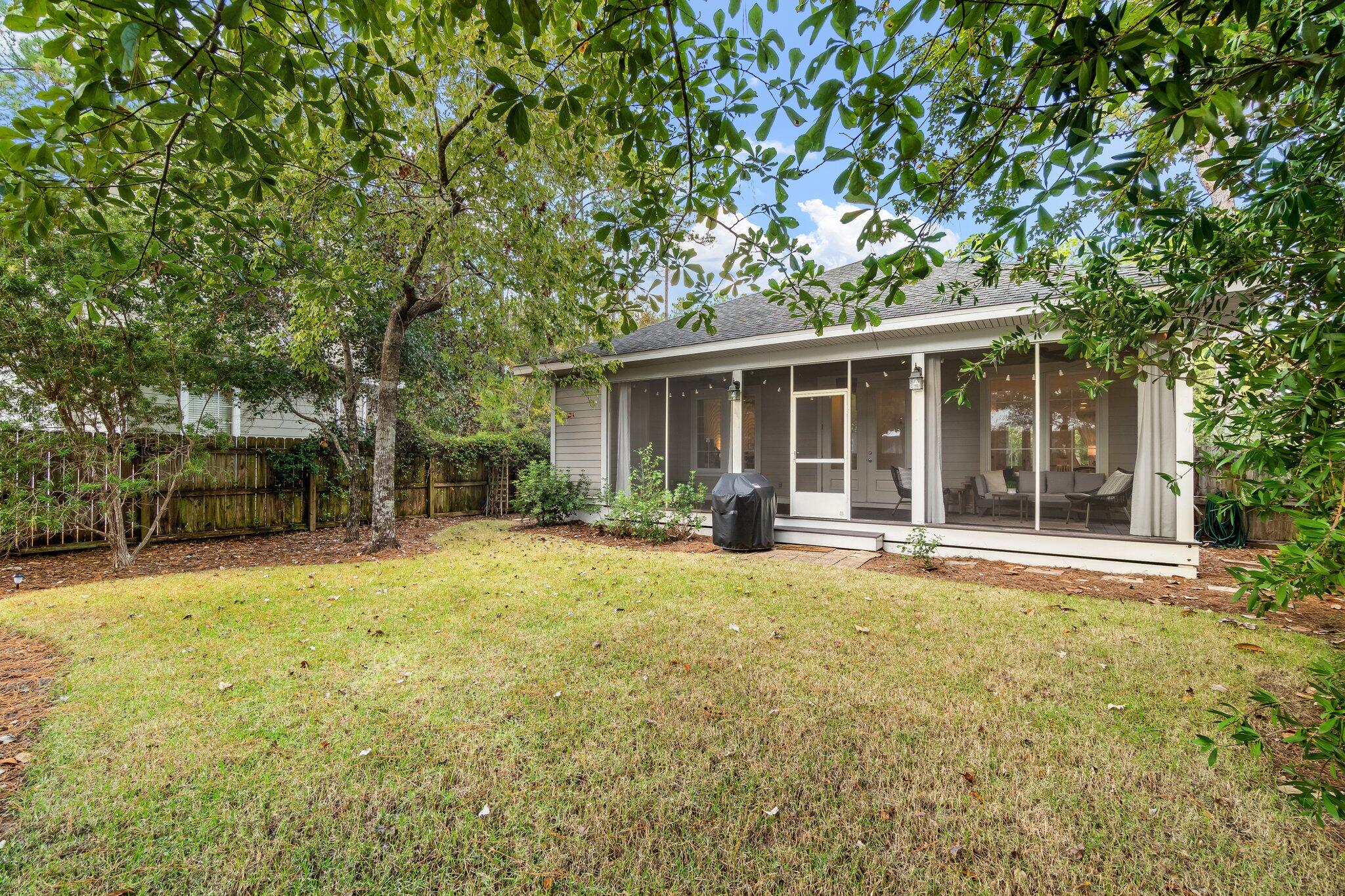 124 East Wild Blueberry Way Santa Rosa Beach, FL 32459 - Photo 29 of 38 a house with trees in front of it
