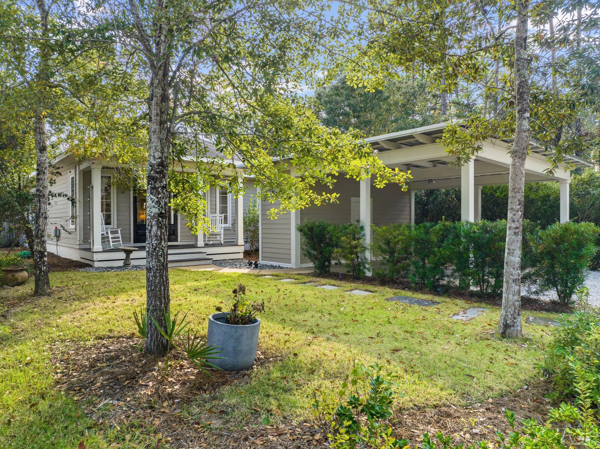 124 East Wild Blueberry Way Santa Rosa Beach, FL 32459 - Photo 32 of 38 a view of a house with backyard and garden