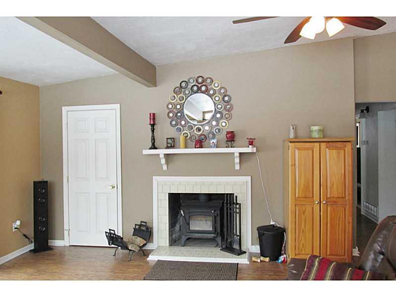 218 Sunset Road Pittsburgh, PA 15237 - Photo 2 of 17 Living Room. Cozy log burning fireplace in living room with beamed ceiling and ceiling fan.