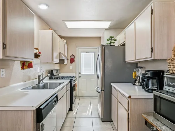 a kitchen with a sink stove and refrigerator