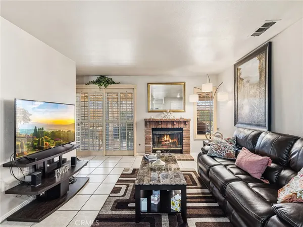 a living room with furniture and a flat screen tv with wooden floor