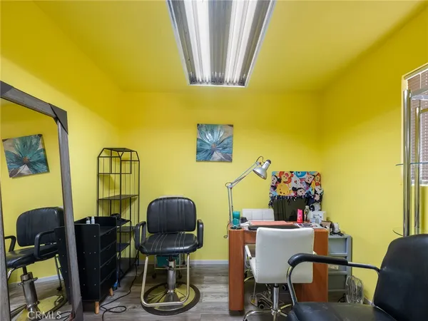 a view of a workspace with furniture and a window