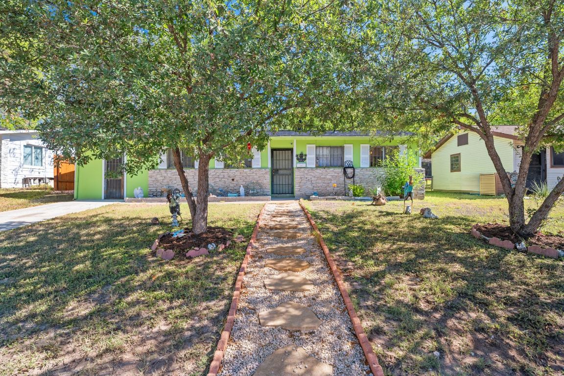 5215 Halmark Drive Austin, TX 78723 - Photo 1 of 1 Shaded front yard with mature trees and a welcoming exterior