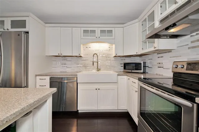 a kitchen with a sink stove and cabinets