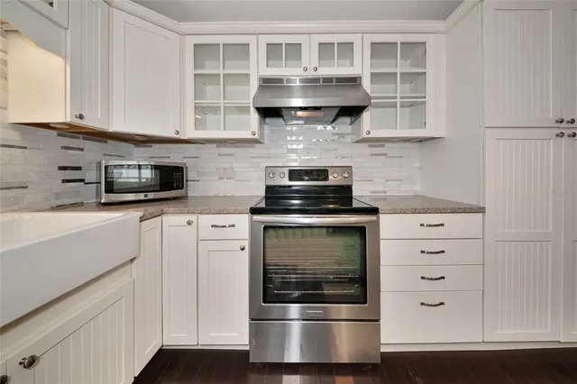 a kitchen with stainless steel appliances granite countertop a stove and a microwave