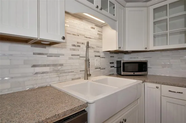 a kitchen with a sink and cabinets