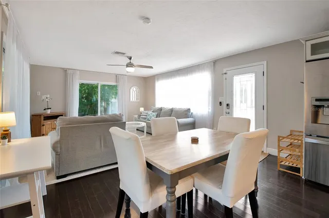 a view of a dining room with furniture and wooden floor