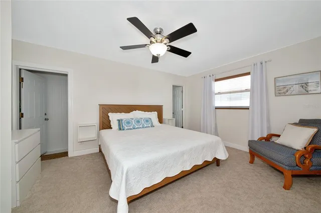 a bedroom with a bed and window