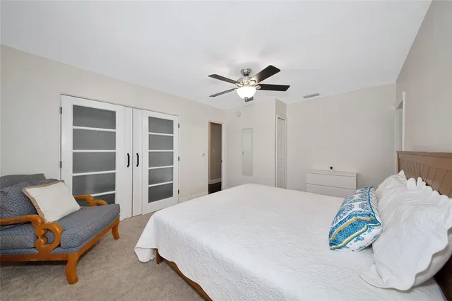 a bedroom with a bed and a chair