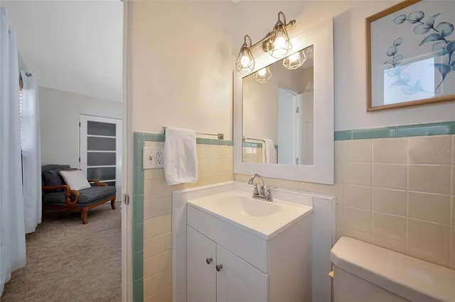 a bathroom with a sink a toilet and a mirror