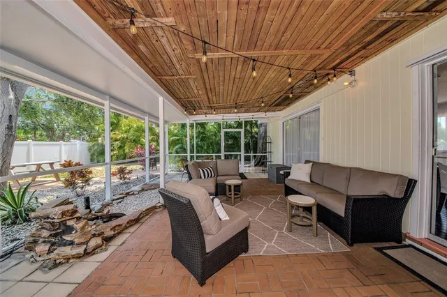 a living room with furniture a large window