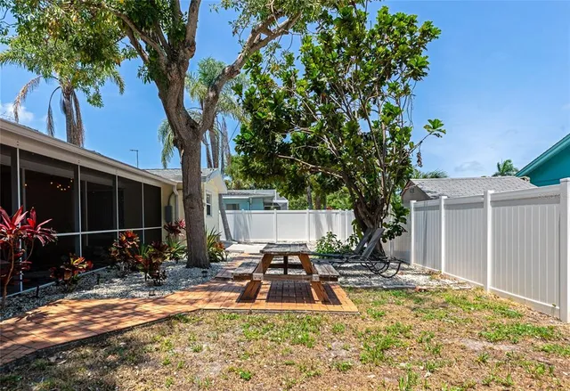a view of a house with backyard porch and sitting area