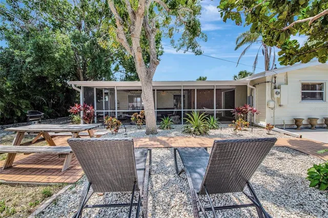 a view of a house with swimming pool and sitting area