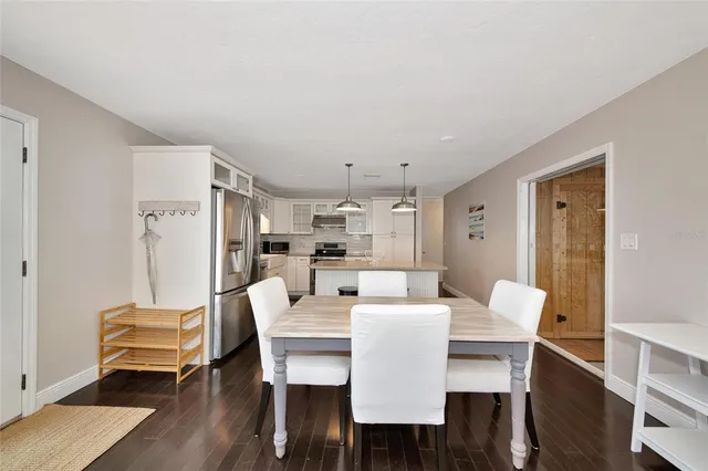 a dining room with furniture a rug and wooden floor