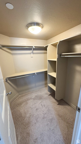 909 South Main Street, Unit F Layton, UT 84041 - Photo 13 of 21 Walk-in closet featuring built-in shelving, chrome hanging rods, recessed lighting, and neutral tone carpet
