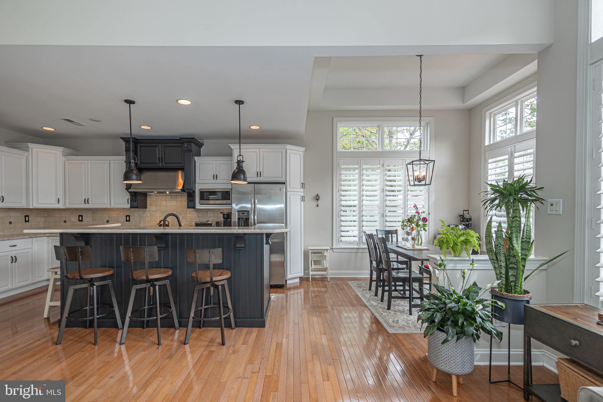 501 Titus Road Lambertville, NJ 08530 - Photo 20 of 62 a kitchen with stainless steel appliances granite countertop wooden floor a dining table chairs and granite counter tops