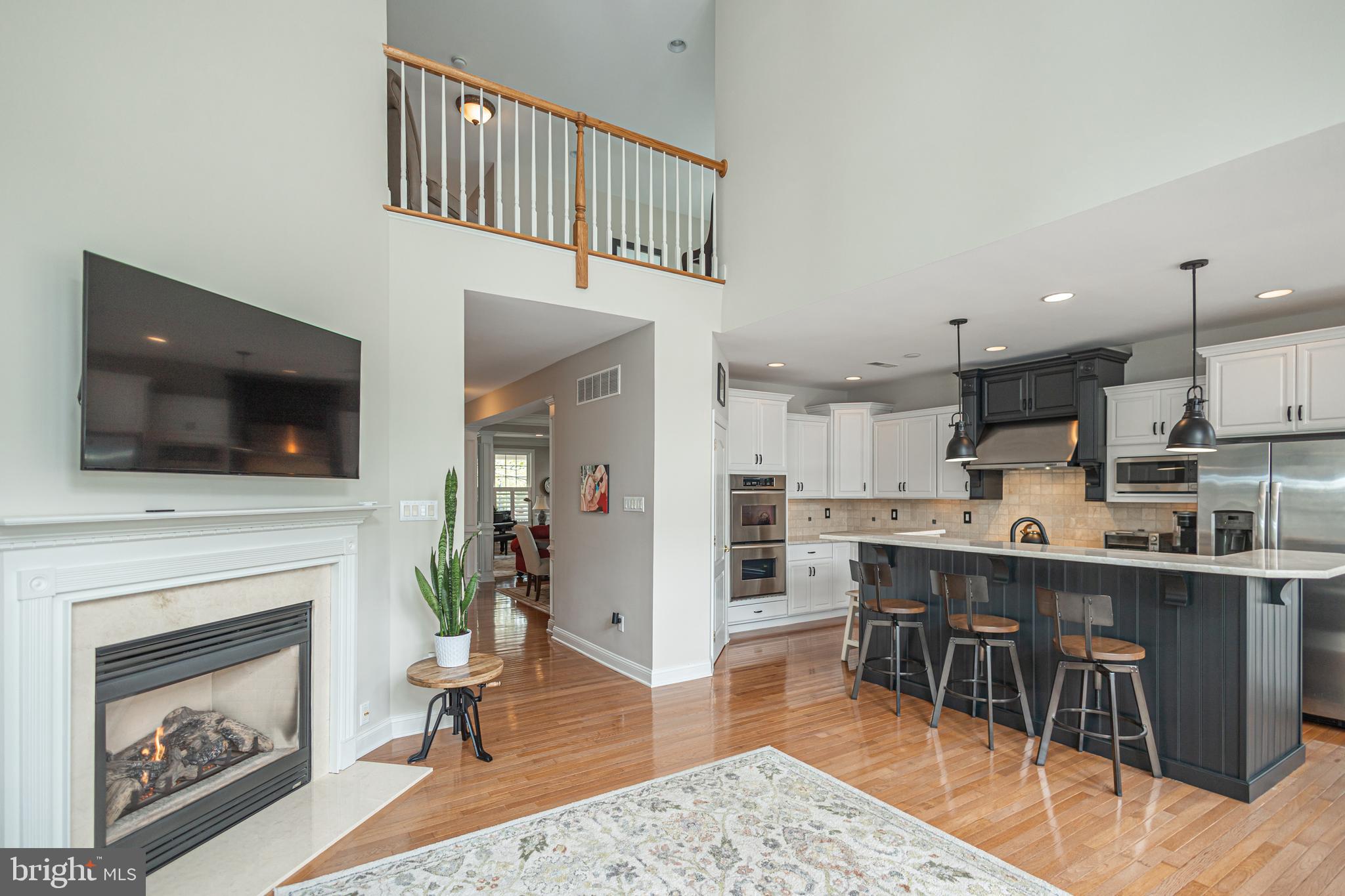 501 Titus Road Lambertville, NJ 08530 - Photo 27 of 62 a living room with stainless steel appliances furniture a fireplace a flat screen tv and a kitchen view