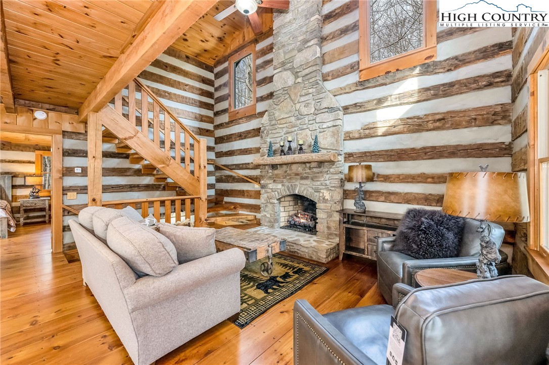372 Homestead Road Todd, NC 28684 - Photo 13 of 41 a living room with furniture a fireplace and a table